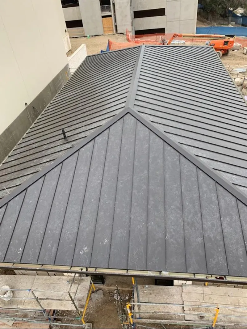 Commercial metal roof construction with crane equipment in Whitestown